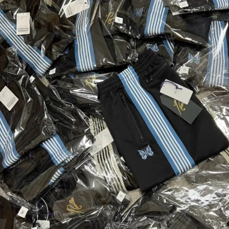 Męskie spodnie igły Awge Kurtki niebieskie motyle haftowe paski czarne spodnie dresowe na siłownię dla mężczyzn kobiety 230515