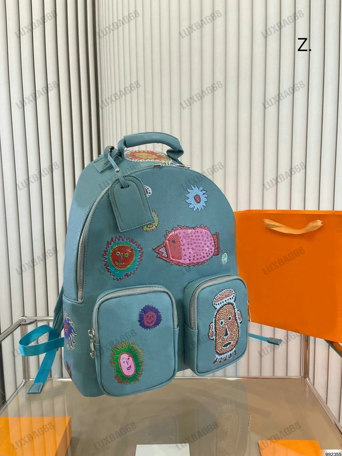 M21714 Blue YK MultiCocket ryggsäck Färgglada ansikten Yayoi Kusama Collection Bag Ultra-funktionell ryggsäck präglad läder SS23 axelväska för man