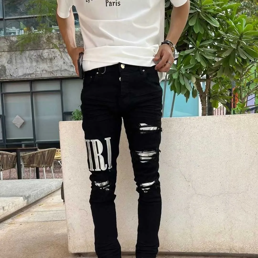 Black ripped jeans with white stripe online