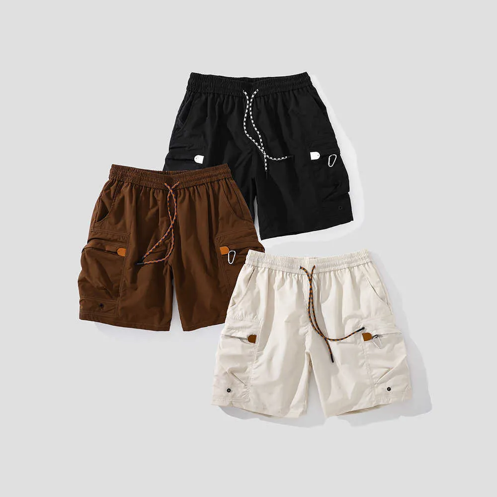 Short fonctionnel à séchage rapide de style montagne américain en plein air, grandes poches zippées de couleur unie pour hommes, taille élastique, pantalon quart ample