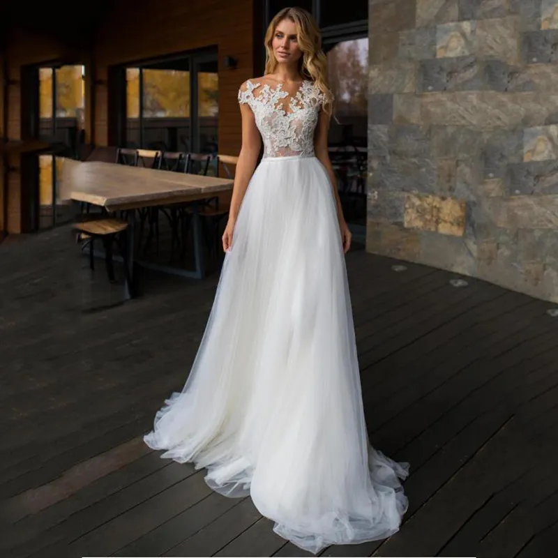 Robe de mariée trapèze en Tulle, effet d'illusion, à la mode, sans manches, ajourée, bouton couvert moderne, application de bijoux