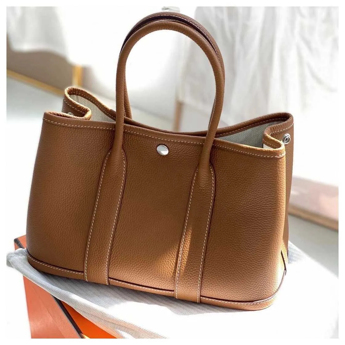 Luxur Designer Tygväskor Hremmss Party Garden Online Store High End Fashion Party Garden Bag Togo Top Leather Hand Women's Big Have Real Logo