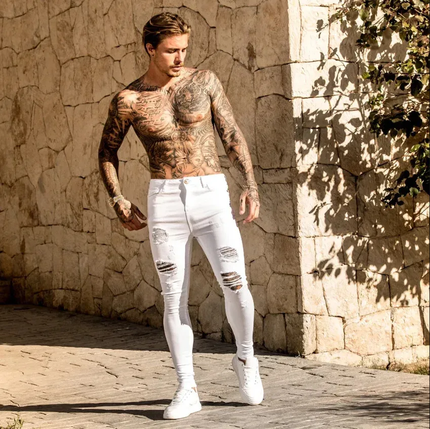 Chude dżinsy Mężczyźni 2023 Elastyczność Slim Pencil Pants Sexy Casual Hole Ripped White Black Denim Mens Ubrania streetwearu 231228