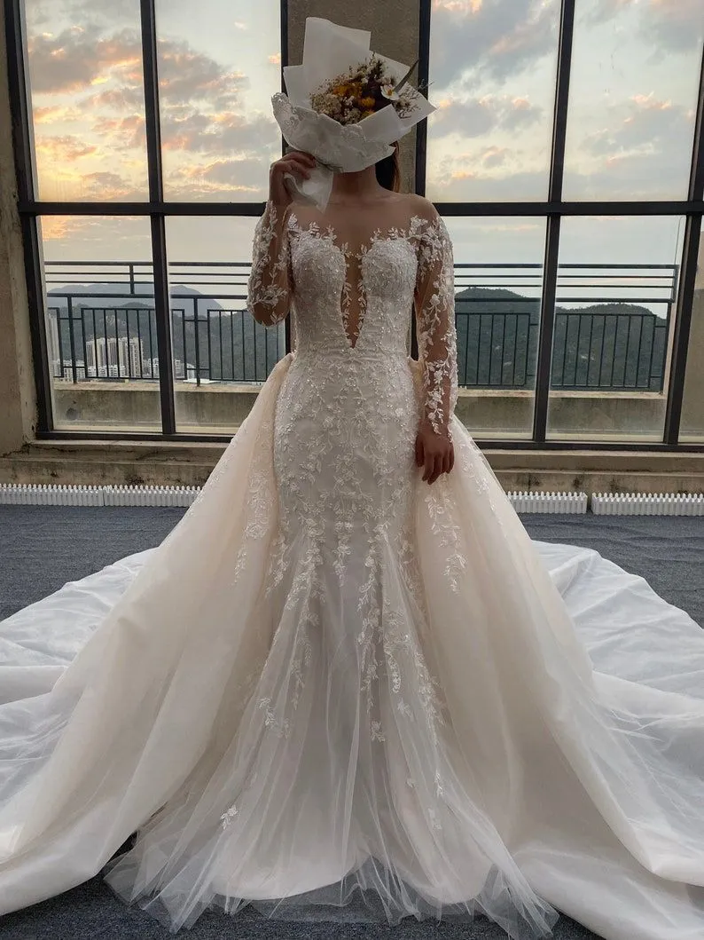 2024 Abiti da sposa sexy Abiti da sposa Applicazioni in pizzo Perline di cristallo Illusione Sirena Maniche lunghe Paese personalizzato Taglie forti Sweep Train Overskirts