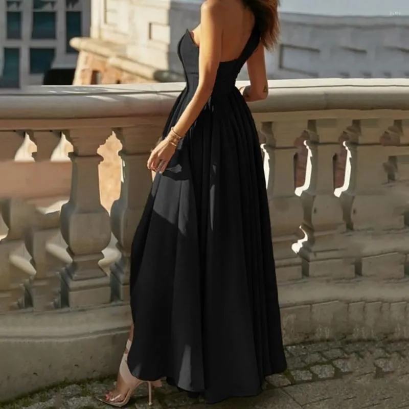 Elegant Black dress with asymmetric pleated hem and hidden zipper detail.