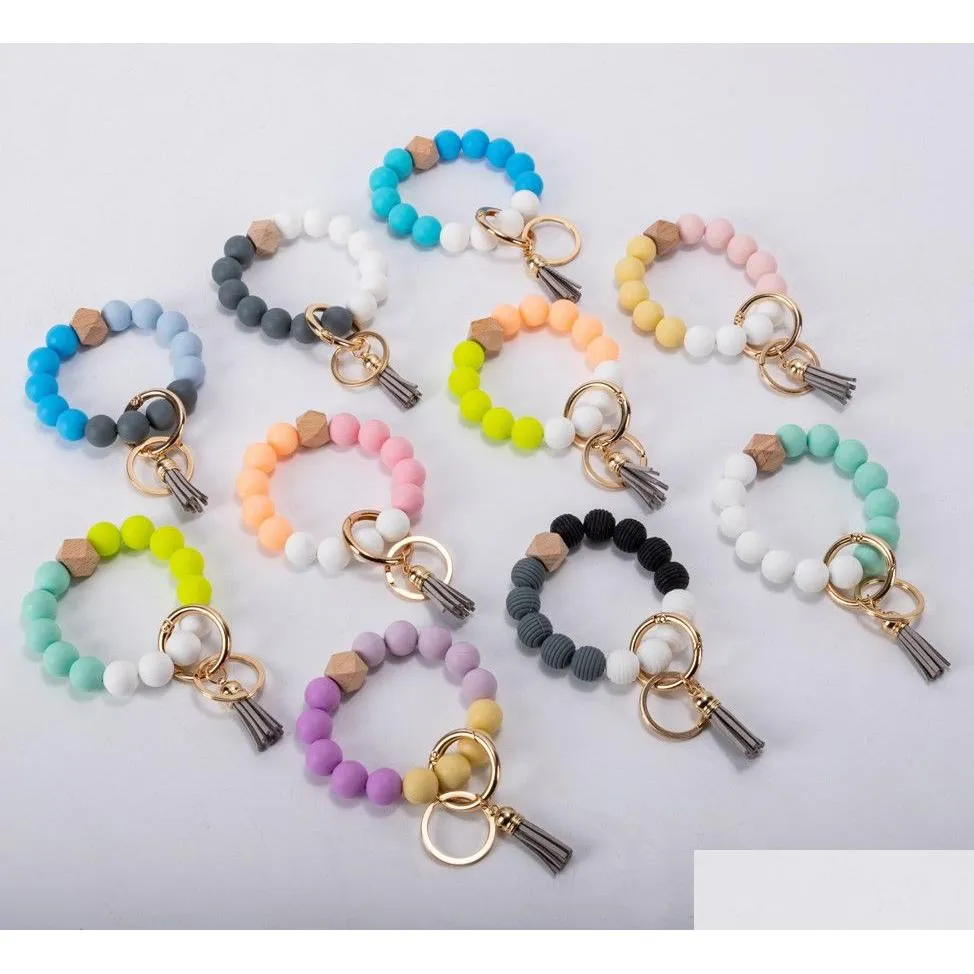 Nyckelringar Festtillbehör Tofsar Träpärla Nyckelring Sile Beads Armband Läderring Livsmedelsklass Sil Wrist Nyckelringar Hänge Drop Del Dhvs5