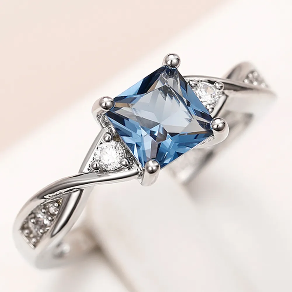 Huitan Zarte Damen-Ringe mit blauem Zirkonia, verdrehtes Design, eleganter Damen-Fingerring für Jubiläumsfeier 2022, neuer Schmuck