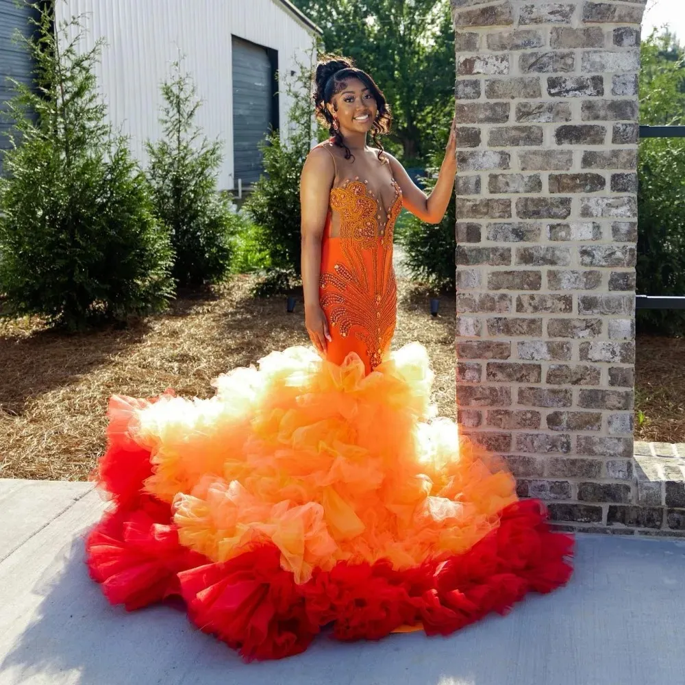 orange backless prom dresses Mermaid Orange Mermaid prom dresses with Orange Beaded Backless Design, Rhinestones, Sheer Jewel Neckline, Tulle Skirt, and Ruffled Skorts