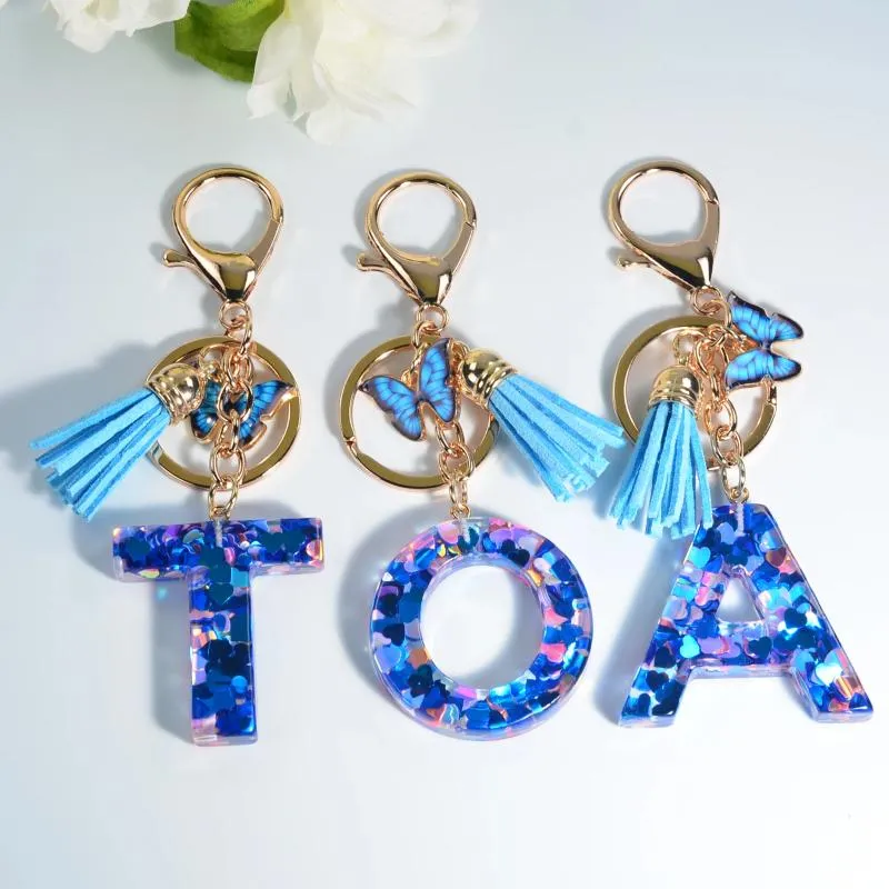 Chaveiros moda coração em forma de lantejoulas cheias de resina letras com borlas bolsa feminina encantadora borboleta azul pingente carro chaveiro