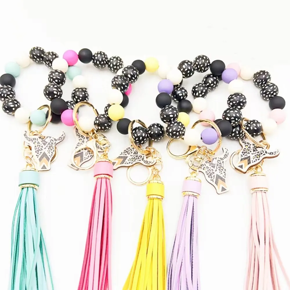 Wholesale of cross-border new bracelets, keychains, printed wooden bead beads, PU leather tassel pendants, keyrings