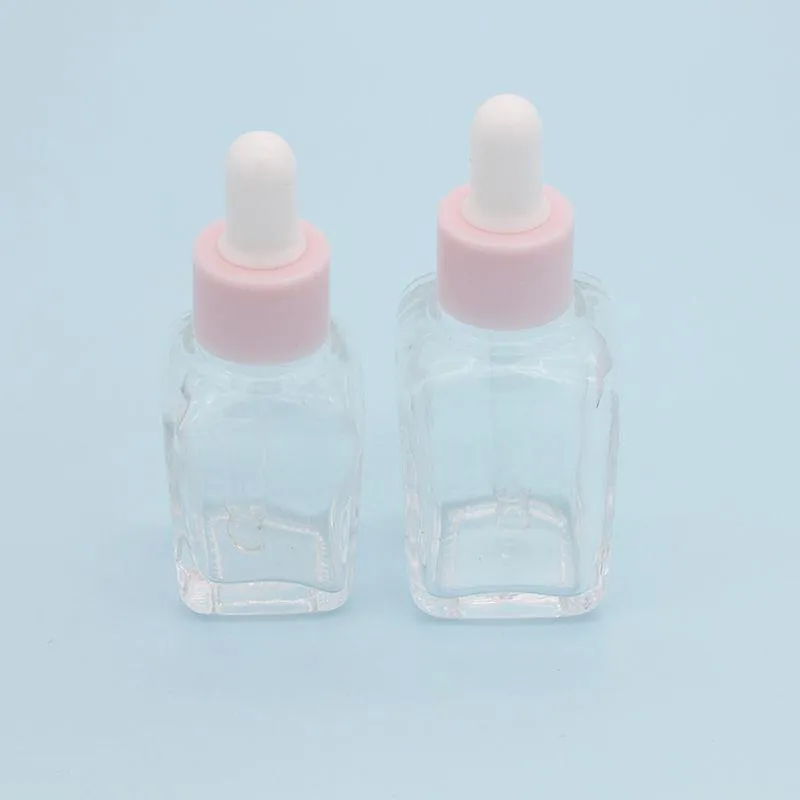 20 ml Esseting Oil Square Droper Bottle 30 ml Clear Glass Serum -flaskor med rosa mössa för kosmetisk SMUQP