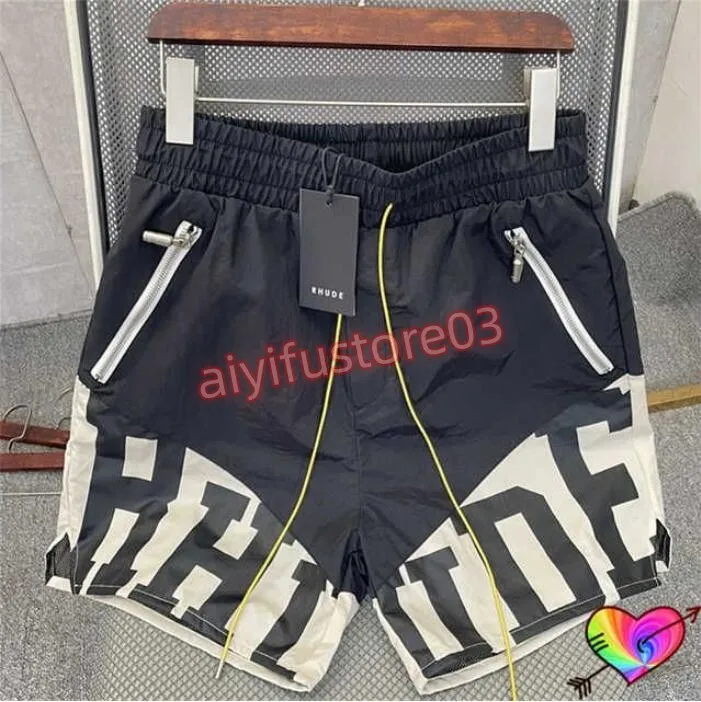 2024 pantalones cortos para hombre Rhude diseñador pantalones cortos de verano de secado rápido de malla transpirable con cordón ropa de playa pantalones cortos deportivos sueltos para hombres