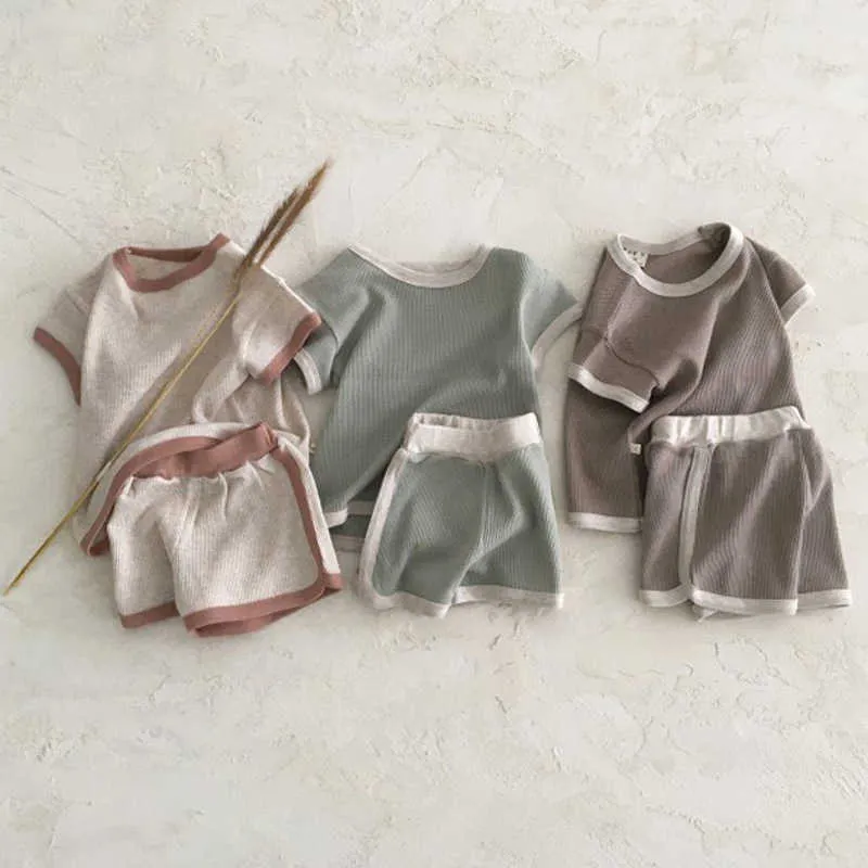 Set di abbigliamento L'abbigliamento per bambini coreano per bambini rende il vecchio colore sport per il tempo libero vestito a maniche corte set da due pezzi in cotone estivo da uomo e da donna