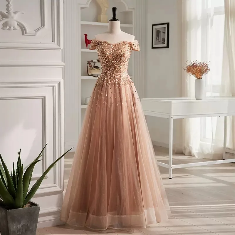 Blush champagne aftonkl￤nningar som lyser paljetter p￤rlor topp prom kl￤nningar fr￥n axeln sn￶rning formell kl￤nning