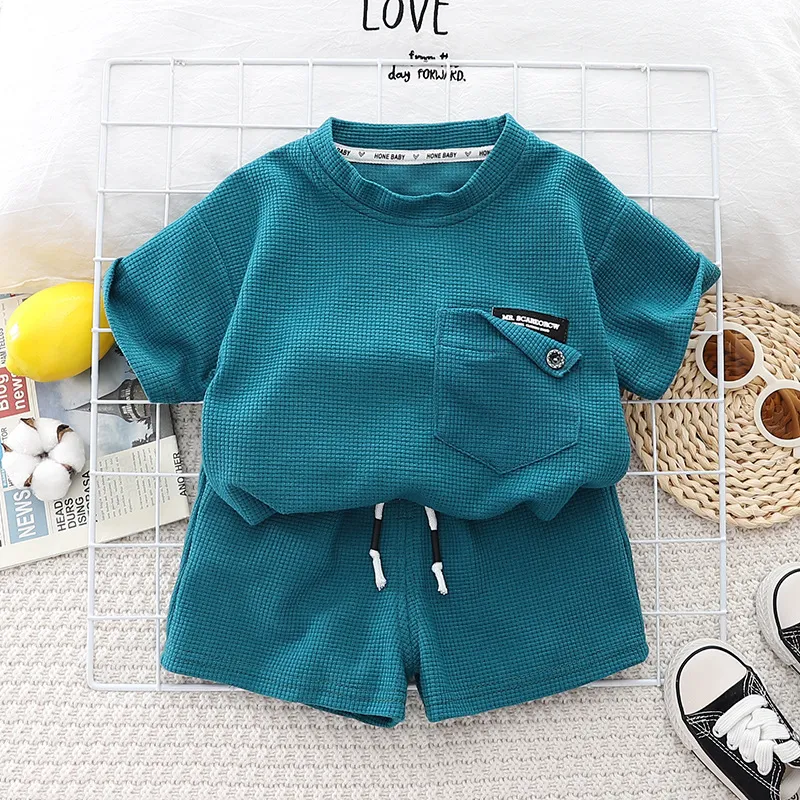 2023 Summer Baby Cotton Ropa de algodón Niña Camisas de manga corta Camisetas Conjuntos de cultivo para niños Top sólidos y pantalones