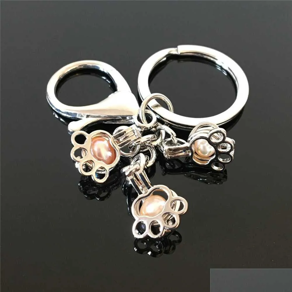 Keychains Lanyards Euro -Amerikaanse pootafdruk Pearl Cage Key Ring kan holle noctilucte vulkanische stenen hanger Keyring druppel delive D3O