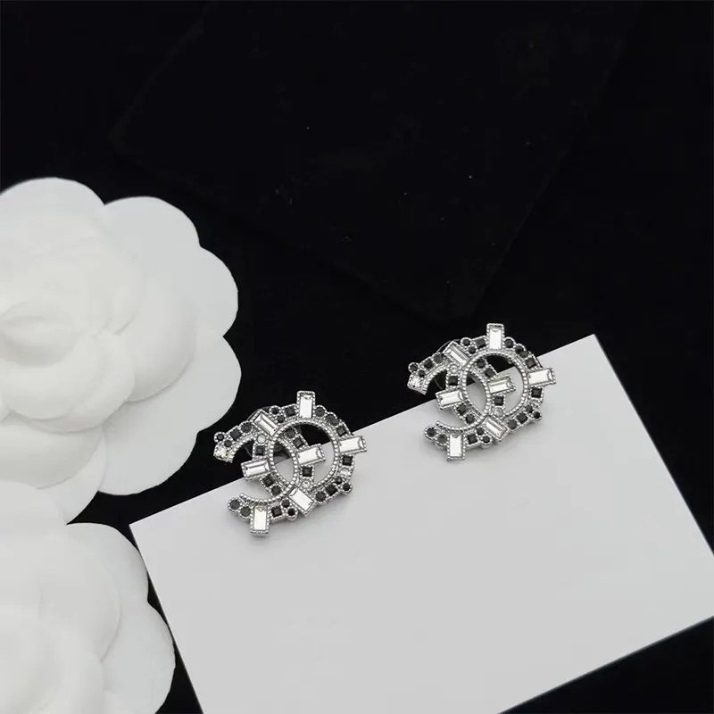 Stand Out - Designer Earrings with Princess cut and Emerald cut Emerald  Essence set in four prongs with Melee set artistic designs in between which  adds more sparkles and makes it outstanding,