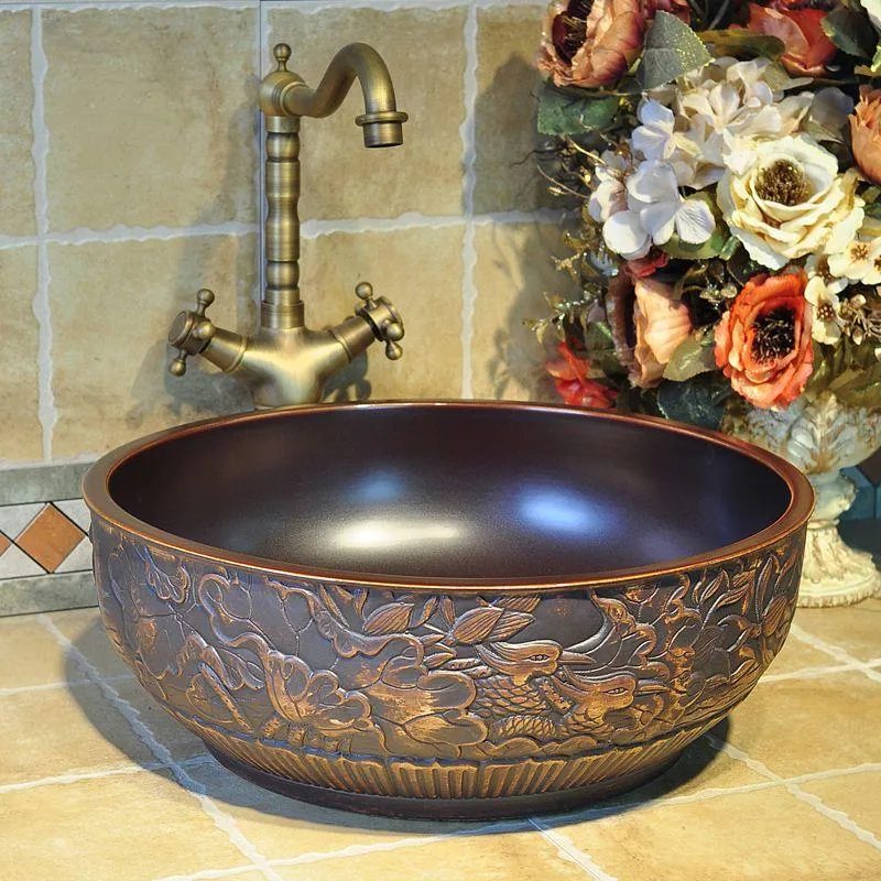 China Artistic Handmade Ceramic Bathroom Sinks Lavobo Round Countertop elegant wash basin brown carving bird pattern Pssjd