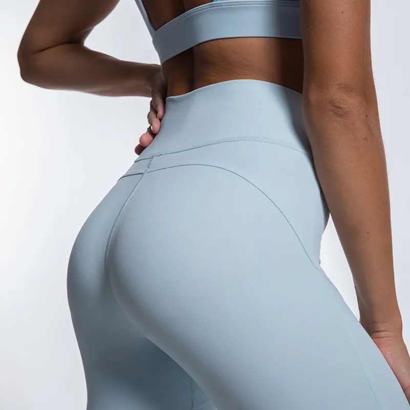 Soutien-gorge de sport de conception creuse de couleur unie ajustée européenne et américaine taille haute Nude Feel Fitness Pantalon Yoga Suit