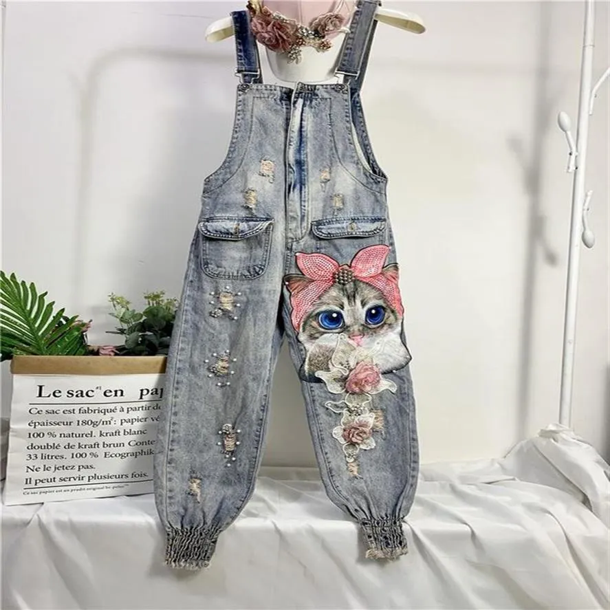 Kvinnors jumpsuits rompers kvinnor trycker tecknad denim jumpsuit overaller hål lösa pärlstav jean pants kvinna plus size casual 222r