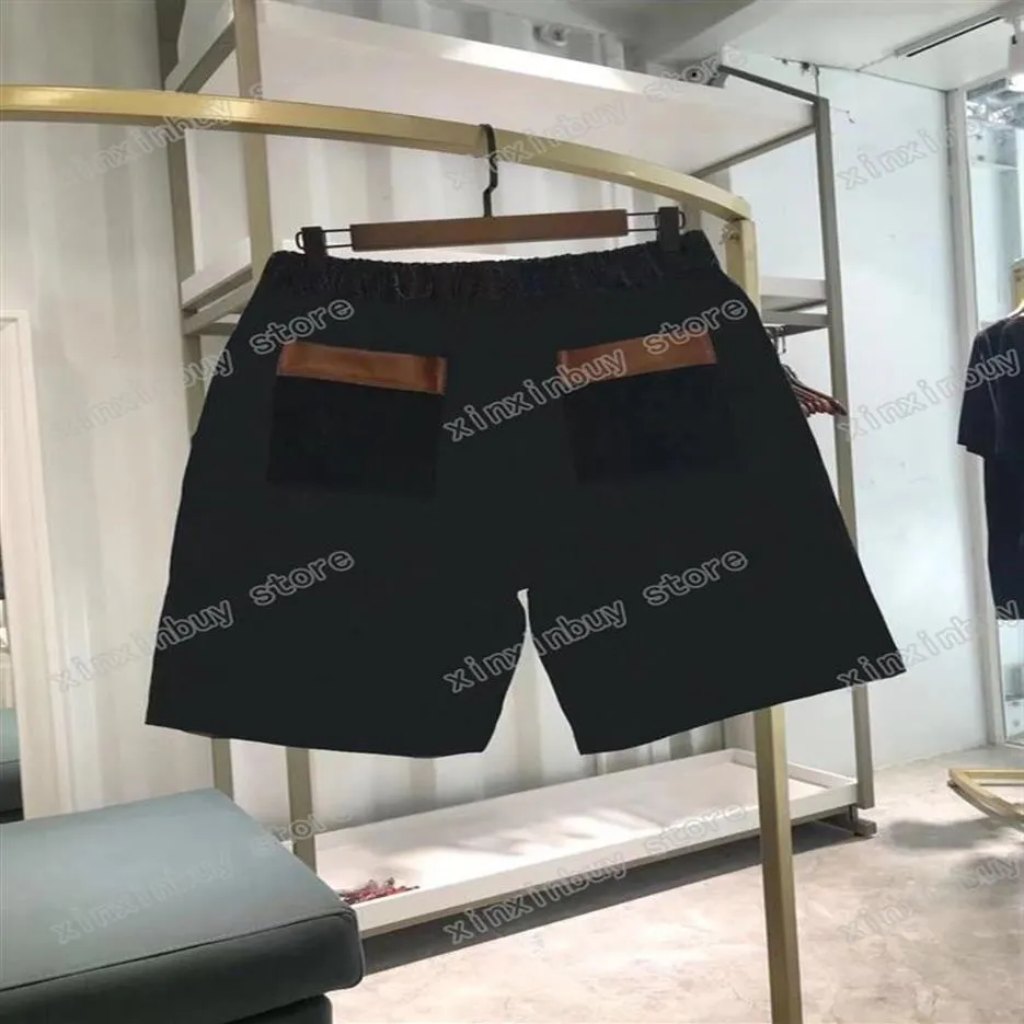 22SS Męskie kobiety designerskie spodnie spodnie skórzane kieszonkowe litery Jacquard wiosenne lato mężczyzn Mężczyzn Postaw spodni swobodny liter