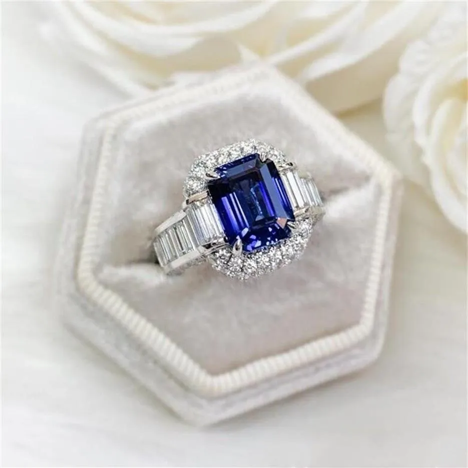 豪華な宝石の結婚指輪925スターリングシルバープリンセスカットブルーサファイアCZダイヤモンドモイサナイトパーティー女性エンゲージメントブライダルRI171I