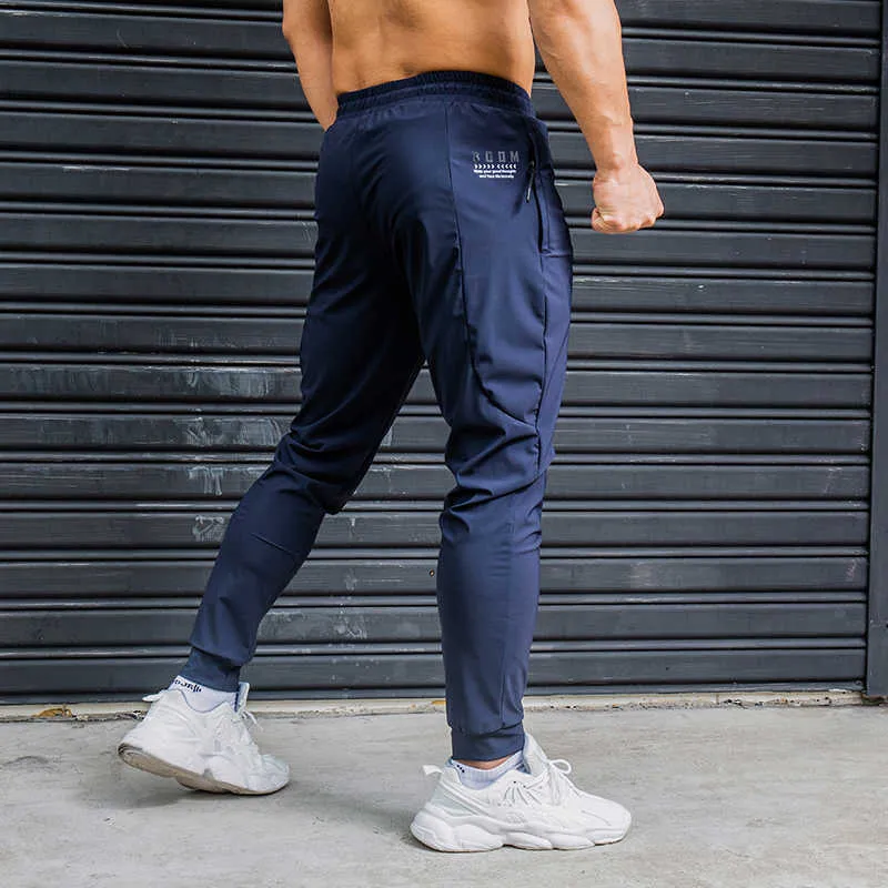 Calça masculina elasticidade homens correndo calças casuais calças de moletom com zíper bolsos treinando jogging academ