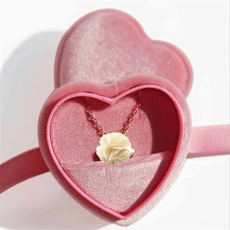 Heart shaped velvet wedding ring box. Red velvet jewelry gift box in a  shape of a heart with gold engagement ring. Stock Photo | Adobe Stock