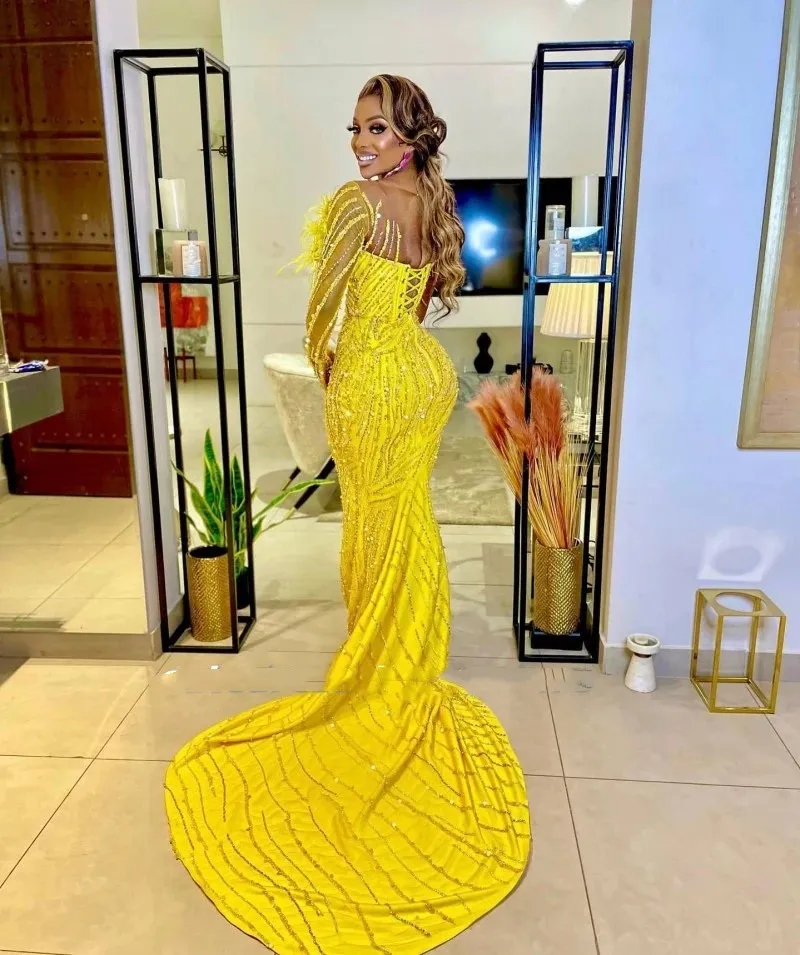 Yellow Ormal Yellow evening gown with Mor Beading, Sheer Neckline, One Shoulder, Feathers, and Mermaid Style - Perfect for Prom, Parties, or Special Yellow Ormal Yellow evening gown with Mor Beading, Sheer Neckline, One Shoulder, Feathers, and Mermaid Style - Perfect for Prom, Parties, or Special