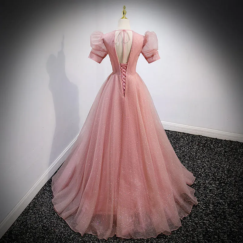 Elegant pink prom dress with appliques, pearl, and sequined detailing.