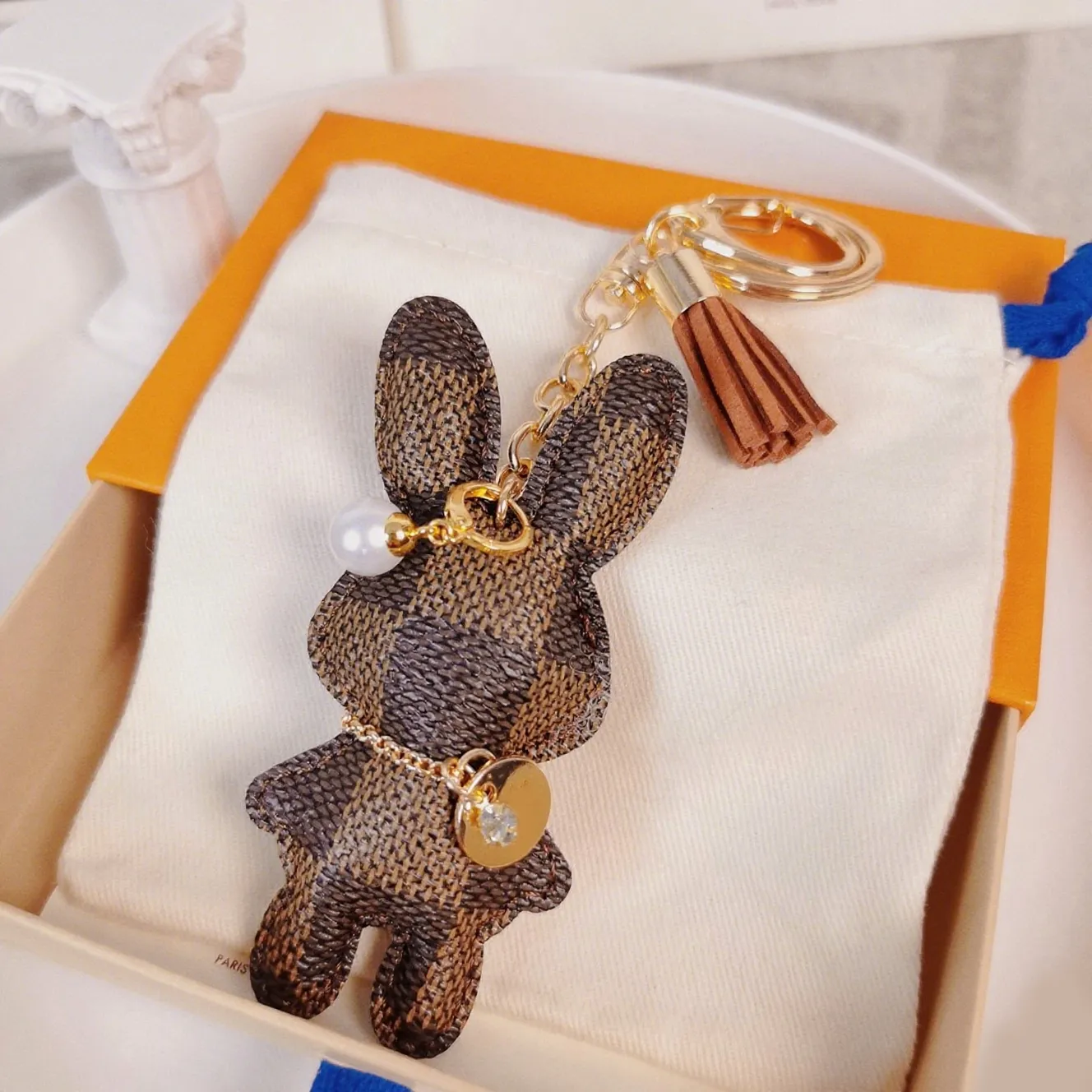 Brown Pebbled Leather Animal Shape Keychain with Gold Chain and Pearl ...