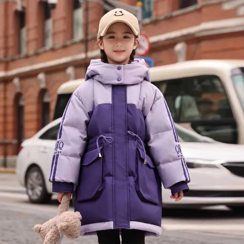 A cheerful young girl wearing a winter jacket Stock Photo - Alamy