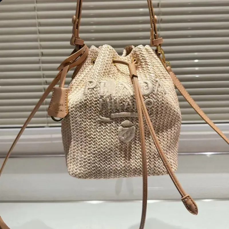 High-end designer bag bucket bag leisure straw woven material leisure sports bag can be carried across the body 