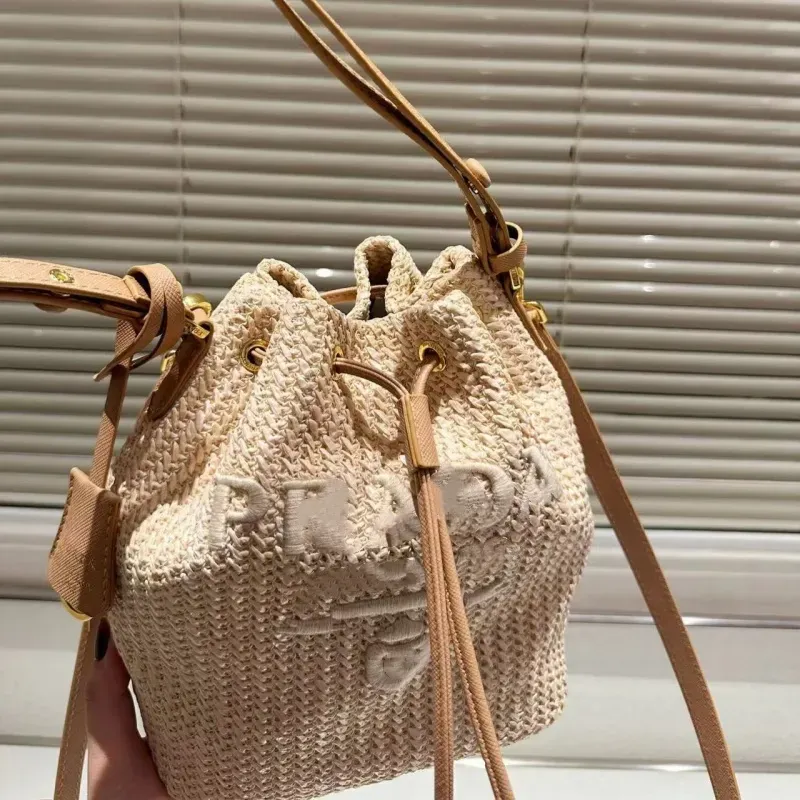 High-end designer bag bucket bag leisure straw woven material leisure sports bag can be carried across the body 