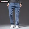 Plus size 40 42 44 outono masculino azul reto solto jeans negócios casual algodão estiramento denim calças masculinas marca 240106