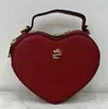 Bolsos de hombro encantadores en forma de corazón a la moda para mujer, bolsos cruzados de cuero PU para mujer, bolsos de mano informales Vintage