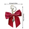 Söt stor bowknot hänge nyckelringar kvinnor fast färg imitera silkesband nyckelringar bil nyckelhållare väskor hängande ornament