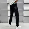 Мужские джинсы Дизайнер Гуанчжоу Xintang Cotton Bullet Корейское издание Slim Fit Высококачественная европейская черная мужская одежда с принтом Medusa X082