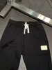 Pantaloni da uomo MMsix Pantaloni sportivi da uomo Disordinato Numero Tag Tasca da donna LOGO Pantaloni da palestra in pelle elastica in vita Recensioni coreane Molti vestiti