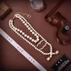 Ny Womens Pearl Earphone -halsband med stämpel lyxiga tröja kedjor flicka par boutique gåva halsbandslåda förpackning av hög kvalitet smycken