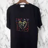 Designer Luxury Laurents Classic Heartbreak, stampa a blocchi di colore con lettere spezzate, T-shirt a maniche corte da uomo e da donna di tendenza, camicie alla moda larghe