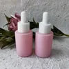 Lagringsflaskor grossisttillverkare anpassad kosmetisk förpackning 20 ml 30 ml frostat rosa glas eterisk oljeflaskdropper