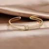 Bracciale con nodo in zircone pieno di lusso AAA placcato oro reale 14K squisito braccialetto regolabile con apertura per festa di nozze da donna 240117