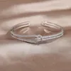 Bracciale con nodo in zircone pieno di lusso AAA placcato oro reale 14K squisito braccialetto regolabile con apertura per festa di nozze da donna 240117