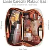 Kosmetiska väskor Portable Makeup Bag öppnar Flat Lay med rem för resor Vattentäta anti-damm stora läderkvinnor