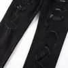 Jean skinny noir pour homme avec patchs brodés de serpent en cuir au genou