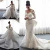 2019 Abiti da sposa a sirena di lusso con strascico staccabile Collo trasparente Applique in pizzo maniche lunghe Fiocco grande Paillettes Cappella Matrimonio Bri291N