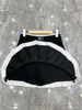 Plus-klänningar 2023 Ny svart sexig street casual designer kjolar kvinnors hög midja metall för att förhindra ljus ut minikjol