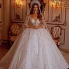 Stunningbride 2024 Arabia Saudita Principessa Ball Gown Abito da sposa Sheer Off Spalla Manica lunga Lusso Pizzo Paillettes Appliques Abiti da sposa Abiti da sposa in cristallo