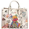 2022 Nowe torebki torebki torebki Kobiety Nowy moda kreskówka graffiti o wysokiej pojemności torba na torba biała skórzana torebka dojeżdże